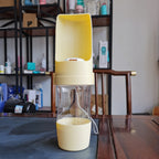 Yellow ROAM Bottle with the trough open, photographed on a table